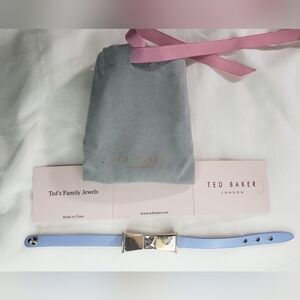 Periwinkle Ted Baker leather/metal bow bracelet. 7 1/2" long. Large gem on bow.